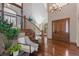 Grand foyer with hardwood floors, staircase, wrought iron railing, high ceilings and modern chandelier at 5414 Golden Currant Way, Parker, CO 80134
