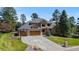 Stunning home featuring a paved driveway, basketball hoop, brick detailing and lush landscaping at 5414 Golden Currant Way, Parker, CO 80134