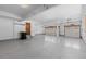 A clean, spacious three-car garage with bright lighting and painted floors at 5414 Golden Currant Way, Parker, CO 80134
