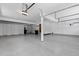 Spacious three-car garage with bright lighting and painted floors at 5414 Golden Currant Way, Parker, CO 80134