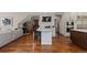 Bright kitchen features hardwood floors, large island with bar stool seating, and stainless steel appliances at 5414 Golden Currant Way, Parker, CO 80134
