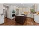 Modern kitchen features custom cabinetry, granite countertops, and a stainless steel refrigerator and oven at 5414 Golden Currant Way, Parker, CO 80134