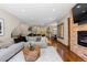 Open concept living room with hardwood floors, fireplace and seamless flow to kitchen and dining areas at 5414 Golden Currant Way, Parker, CO 80134