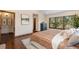 Comfortable main bedroom showcasing a large window and decorative pillows and a textured comforter at 5414 Golden Currant Way, Parker, CO 80134