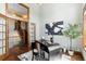 Stylish office features hardwood floors, a modern desk, and a view of the staircase at 5414 Golden Currant Way, Parker, CO 80134