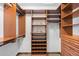 Spacious walk-in closet with wood shelving and drawers, perfect for organized storage at 5414 Golden Currant Way, Parker, CO 80134