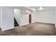 Spacious finished basement with carpeted floors and painted white walls at 7618 Umatilla St, Denver, CO 80221