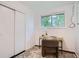 Bedroom with a desk, chair, large closet, and a window for natural light at 7618 Umatilla St, Denver, CO 80221