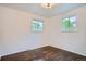 Cozy bedroom with hardwood floors and two windows letting in natural light at 7618 Umatilla St, Denver, CO 80221