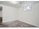 A clean bedroom with plush carpeting and a window at 7618 Umatilla St, Denver, CO 80221