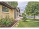 Beautifully landscaped front yard with lush green grass and vibrant flower beds, showcasing the home's charm at 7618 Umatilla St, Denver, CO 80221