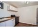 Kitchen featuring a black stove, white cabinets, and a sink at 7618 Umatilla St, Denver, CO 80221