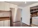 An updated kitchen featuring stainless steel appliances and white cabinets at 7618 Umatilla St, Denver, CO 80221