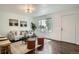 Bright living room with hardwood floors, neutral décor, large window, and comfortable seating with stylish accents at 7618 Umatilla St, Denver, CO 80221