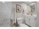 Bathroom features white cabinets, modern fixtures, and marble-look tiled walls at 2260 S Lewiston St, Aurora, CO 80013