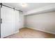 Bedroom featuring light wood-look floors, a closet, and modern lighting at 2260 S Lewiston St, Aurora, CO 80013