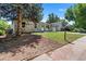 Charming single-story home features stone accents, a well-maintained lawn, and mature trees at 2260 S Lewiston St, Aurora, CO 80013