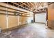 Spacious garage offers exposed beams and storage shelves at 2260 S Lewiston St, Aurora, CO 80013