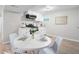 Bright kitchen features white cabinets, stainless steel appliances, and a dining table at 2260 S Lewiston St, Aurora, CO 80013