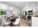 Open concept living room, dining room, and kitchen area with modern stainless steel appliances at 2260 S Lewiston St, Aurora, CO 80013