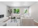 Open living space with a brick fireplace, large window, and stylish neutral furniture arrangement at 2260 S Lewiston St, Aurora, CO 80013