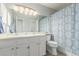 Bright bathroom with a double sink vanity, a large mirror, and a shower with a decorative curtain at 11147 W 17Th Ave # 103, Lakewood, CO 80215
