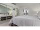 Inviting bedroom with mirrored closet doors, a large window, and comfortable gray furnishings at 11147 W 17Th Ave # 103, Lakewood, CO 80215