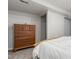 Comfortable bedroom with a closet and a wooden dresser for storage at 11147 W 17Th Ave # 103, Lakewood, CO 80215