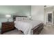 Comfortable bedroom with a rustic wood frame bed, soft carpet, and a relaxing, neutral color scheme at 11147 W 17Th Ave # 103, Lakewood, CO 80215
