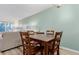 Open dining room with modern table and chairs, connecting to a cozy living space at 11147 W 17Th Ave # 103, Lakewood, CO 80215