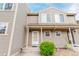 Charming townhouse featuring a covered entryway with decorative shrubbery and a welcoming front door at 11147 W 17Th Ave # 103, Lakewood, CO 80215