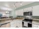 Bright kitchen with stainless steel appliances, granite counters, and an open layout at 11147 W 17Th Ave # 103, Lakewood, CO 80215