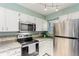 Modern kitchen featuring stainless steel appliances, ample white cabinets, and granite countertops at 11147 W 17Th Ave # 103, Lakewood, CO 80215