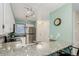 Well-lit kitchen showcasing stainless steel appliances, granite counters, and a convenient breakfast bar at 11147 W 17Th Ave # 103, Lakewood, CO 80215