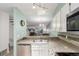 Cozy kitchen features stainless steel appliances, granite countertops, and an open view to the living area at 11147 W 17Th Ave # 103, Lakewood, CO 80215