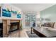 Cozy living room with a brick fireplace, sliding glass door to backyard, and modern decor at 11147 W 17Th Ave # 103, Lakewood, CO 80215