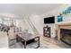 Spacious living room featuring a fireplace, TV, staircase, and open floor plan at 11147 W 17Th Ave # 103, Lakewood, CO 80215