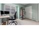 Comfortable home office space with a desk, ergonomic chair, shelving, and natural light at 11147 W 17Th Ave # 103, Lakewood, CO 80215