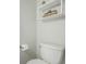 Modern toilet with a wall-mounted shelf, a tissue paper roll, and clean white porcelain at 11147 W 17Th Ave # 103, Lakewood, CO 80215