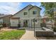 Two-story home with nice backyard and patio furniture with a grill on brick paved area at 11355 Haswell Dr, Parker, CO 80134