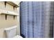 The bathroom features a toilet, shower curtain, and wood shelves at 11355 Haswell Dr, Parker, CO 80134