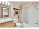 Bathroom with shower and tub combination, decorative shower curtain, shelving, and sink at 11355 Haswell Dr, Parker, CO 80134