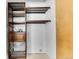 Walk-in closet with custom wood shelving and hanging storage with tile floors at 11355 Haswell Dr, Parker, CO 80134