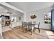 Open-concept living and dining area featuring hardwood floors and a fireplace at 11355 Haswell Dr, Parker, CO 80134