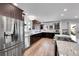 Modern kitchen featuring stainless steel appliances, granite countertops, and dark wood cabinets at 11355 Haswell Dr, Parker, CO 80134