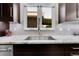 Close up view of a modern kitchen sink, faucet, countertops, and backsplash at 11355 Haswell Dr, Parker, CO 80134
