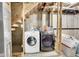 Laundry room in unfinished basement under stairs with newer washer and dryer at 11355 Haswell Dr, Parker, CO 80134