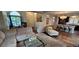 Open-concept living room featuring a sofa, glass coffee table, and view into dining and kitchen areas at 11355 Haswell Dr, Parker, CO 80134