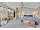 Large bedroom with a vaulted ceiling, connecting bathroom, a bed and a chest at 11355 Haswell Dr, Parker, CO 80134