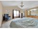 Bedroom with vaulted ceiling, bright windows, carpet, and entry into a bathroom at 11355 Haswell Dr, Parker, CO 80134